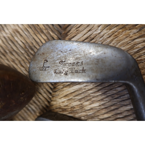 13 - A collection of vintage golf clubs, and a bag