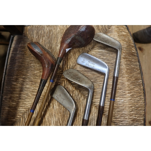 13 - A collection of vintage golf clubs, and a bag