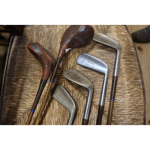 13 - A collection of vintage golf clubs, and a bag