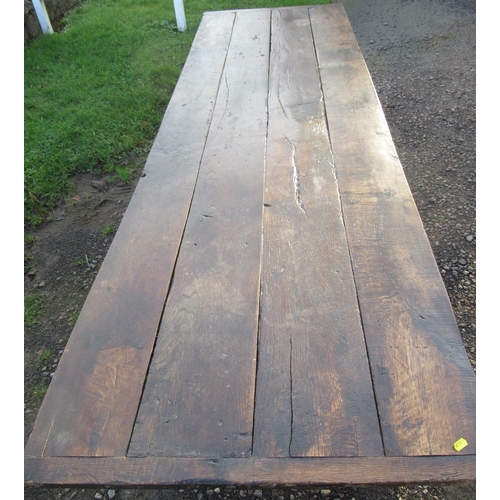 15 - An antique oak rectangular farm house table, with four plank cleated top, raised on square legs, 31i... 