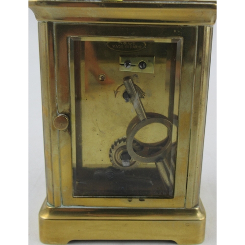 189 - A brass cased carriage clock, with white enamel dial and Roman numerals, stamped R & Co Made in Pari... 