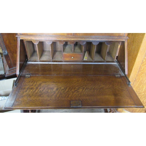 21 - An oak bureau bookcase, with leaded glass decoration, height 79ins, width 34ins