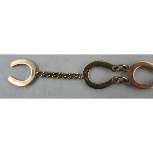 239 - A 9ct gold bracelet, made up of horseshoes joined by chains, marked 375, weight 9.5g, in a Garrard a... 