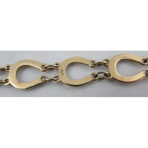 239 - A 9ct gold bracelet, made up of horseshoes joined by chains, marked 375, weight 9.5g, in a Garrard a... 