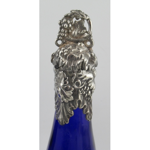 245 - A pair of Bristol blue glass decanter bottles, with silver plated vine mounts, together with a bottl... 