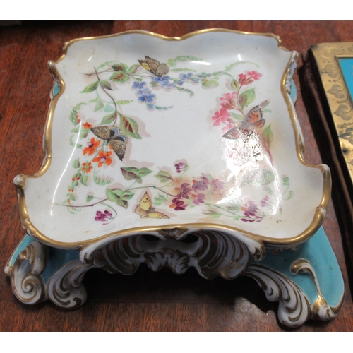 247 - A 19th century porcelain stand, of square form, decorated with butterflies and flowers, to a scroll ... 