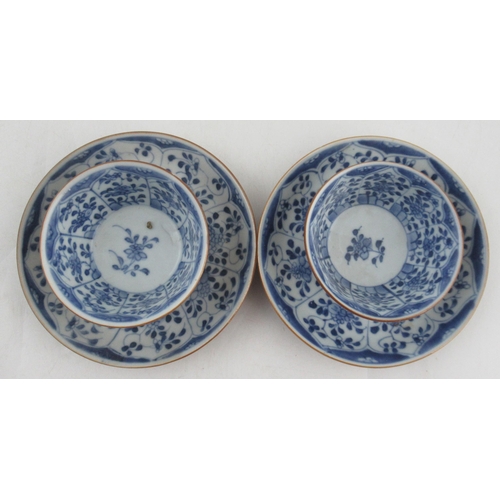 265 - Two Chinese porcelain café au lait tea bowls and saucers, decorated with blue and white flowers