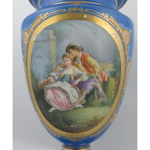 273 - A Continental porcelain pedestal vase, decorated with an oval panel of figures seated in a garden an... 