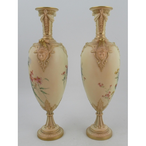 316 - A pair of Royal Worcester blushed ivory vase, decorated with thistles and having masked handles, sha... 