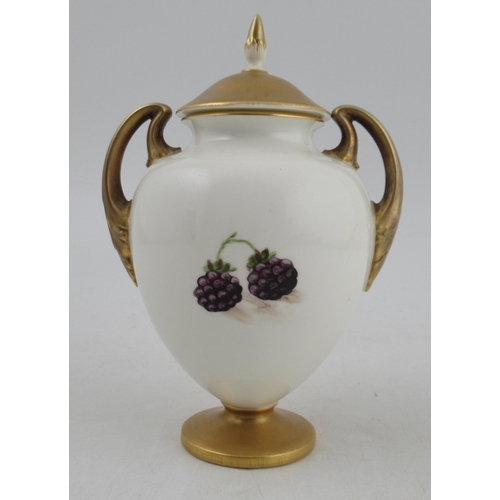 319 - A Royal Worcester covered pedestal vase, decorated to the front with fruit to a mossy background by ... 