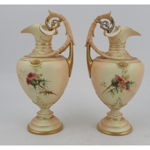 328 - A pair of Royal Worcester blush ivory ewers, decorated with roses, with scrolling handles, shape No ... 