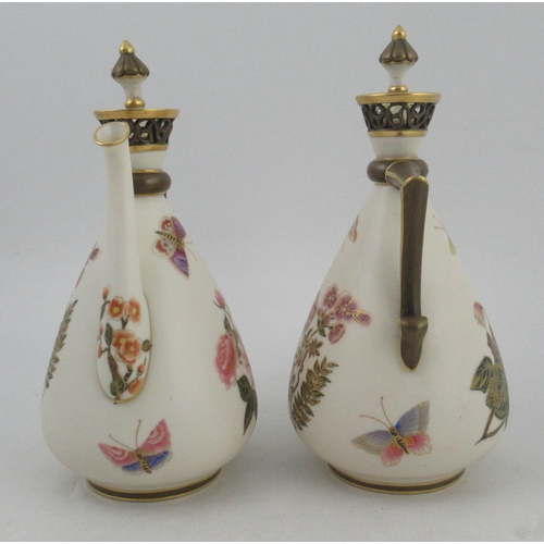 339 - A pair of Royal Worcester Persian style gilt ivory ewers, with stoppers and pierced necks, decorated... 