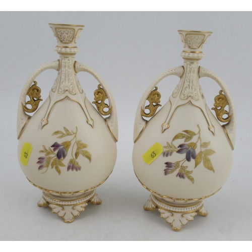 358 - A pair of Royal Worcester glided ivory vases, with two hoop handles, shape No 1142, height 8.25ins