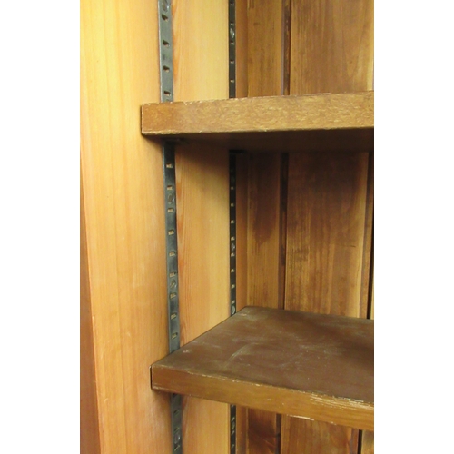 36 - A pine double bookcase, with sliding glazed doors and adjustable shelves, height 78ins, width 50ins,... 