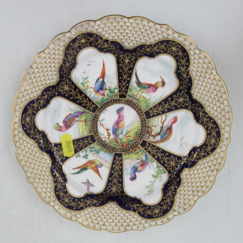 413 - A Royal Worcester cabinet plate, decorated with reserve panels of fabulous birds to a shaped boarder... 