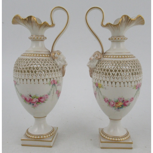 465 - A pair of Royal Worcester pierced ewers, by George Owen, painted with garlands of flowers by Phillip... 