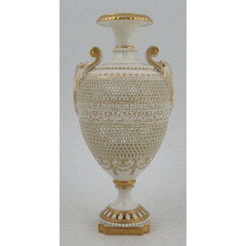 466 - A Royal Worcester pierced vase, by George Owen, raised on a rebated square base with two gilt lug ha... 