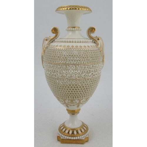 466 - A Royal Worcester pierced vase, by George Owen, raised on a rebated square base with two gilt lug ha... 