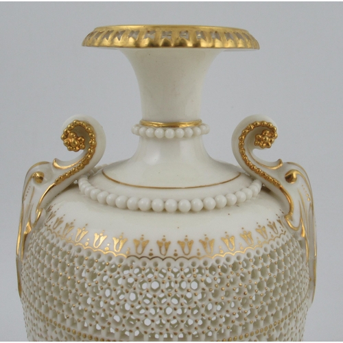 466 - A Royal Worcester pierced vase, by George Owen, raised on a rebated square base with two gilt lug ha... 