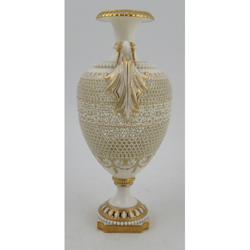 466 - A Royal Worcester pierced vase, by George Owen, raised on a rebated square base with two gilt lug ha... 