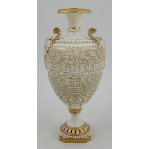 466 - A Royal Worcester pierced vase, by George Owen, raised on a rebated square base with two gilt lug ha... 