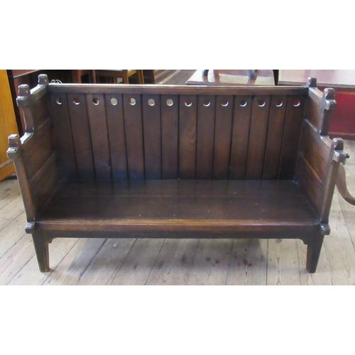 6 - An Arts and Crafts style child's oak settle, with carrying handles and supports in the gothic style,... 