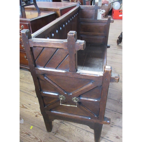 6 - An Arts and Crafts style child's oak settle, with carrying handles and supports in the gothic style,... 