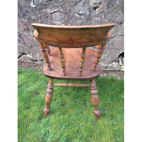 13 - An elm captains chair, with turned spindle back