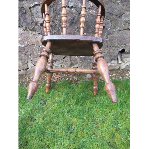 13 - An elm captains chair, with turned spindle back