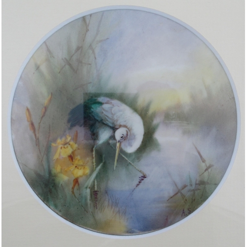 133 - A circular porcelain plaque, believed to be Royal Worcester, decorated with a Heron in water with re... 