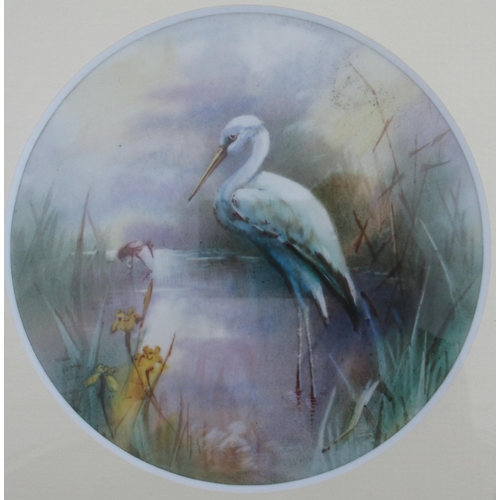 134 - A circular porcelain plaque, believed to be Royal Worcester, decorated with a Heron in water with re... 