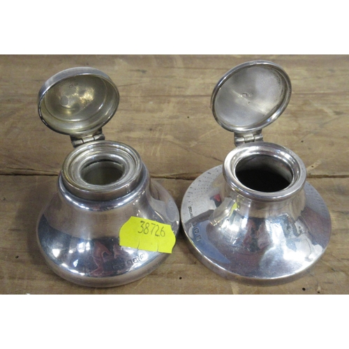 166 - Two silver capstan inkwells, together with other silver and metalware