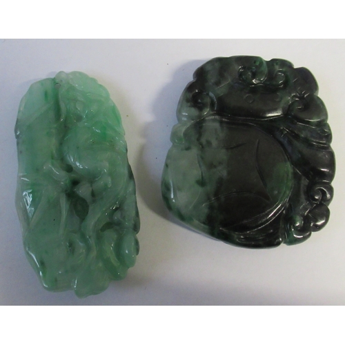 189 - Two green jade style discs, one carved with a mythical beast, the other with foliage, height 2ins an... 