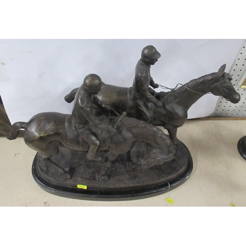 203 - A metal model, of two racehorses with jockeys, signed to the oval base, height 15ins