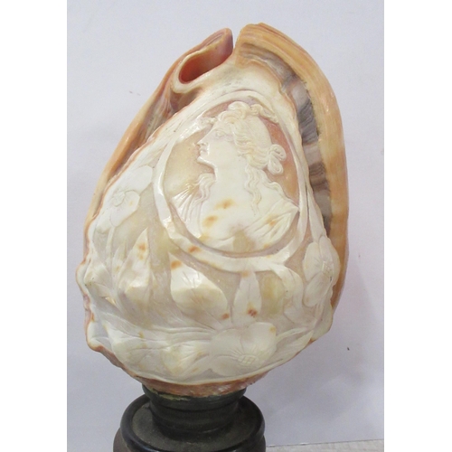 217 - Two carved cameo shells, on wooden stands, height 7.5ins and 8ins