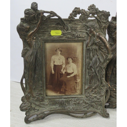 218 - A pair of Art Nouveau style metal photograph frames, decorated with a woman and flowers, marked to b... 