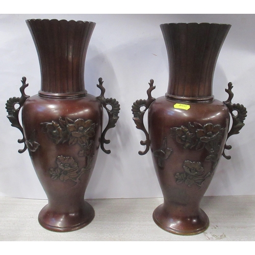 219 - A pair of Eastern metal vases, decorated with flowers, height 14.5ins