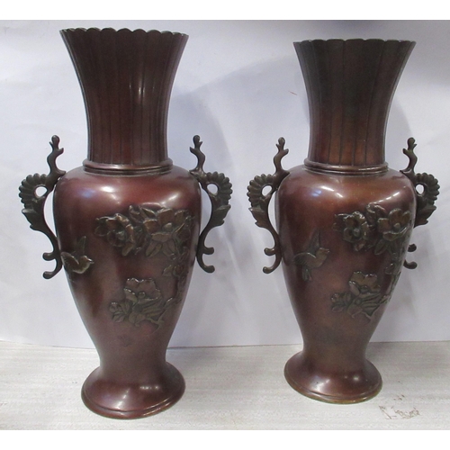 219 - A pair of Eastern metal vases, decorated with flowers, height 14.5ins