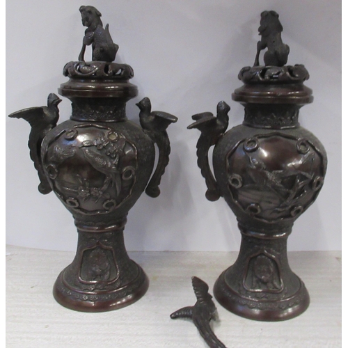 220 - A pair of Eastern metal covered vases, decorated with birds and animals, height 11.5ins