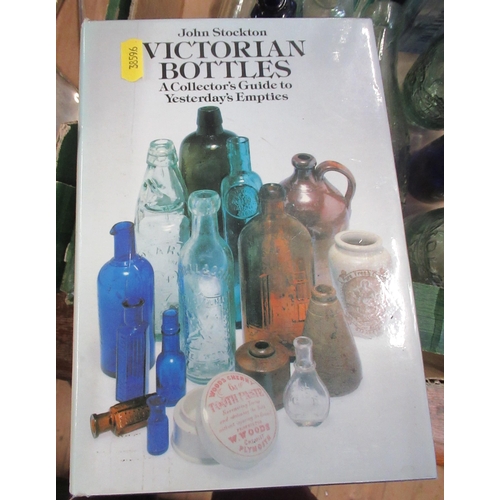 231 - A collection of glass bottles, together with a book, Victorian Bottles by John Stockton