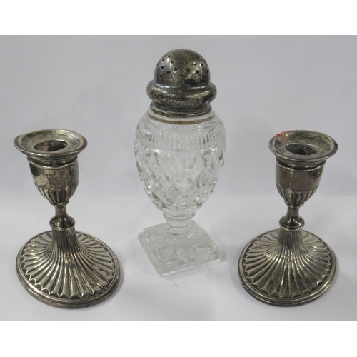 325 - A pair of Victorian silver candlesticks, together with a silver topped pepper