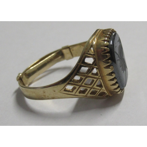 330 - A gold signet ring, set with a carved stone, marked .975, weight 3.7g