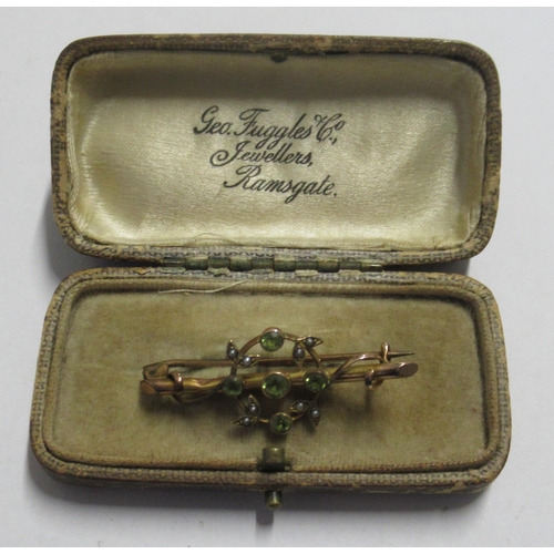 332 - A Victorian 9ct gold bar brooch, set with peridot and seed pearls