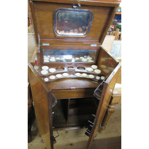 40 - A Wilson & Gill London walnut veneered drinks cabinet, with hinged rising lid, over a pair of doors ... 