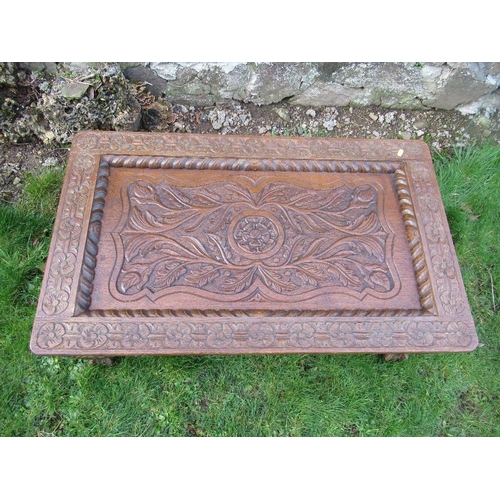 72 - An carved oak coffee table, with glass inset, 39ins x 24ins, height 15ins