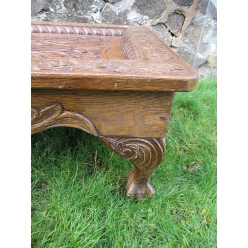 72 - An carved oak coffee table, with glass inset, 39ins x 24ins, height 15ins