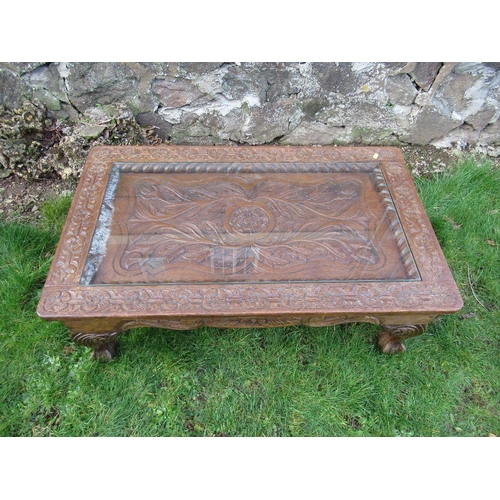 72 - An carved oak coffee table, with glass inset, 39ins x 24ins, height 15ins