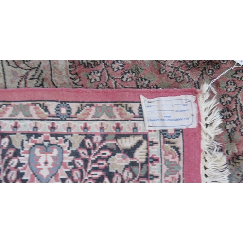 84 - An Indian rug, with scrolling leaf decoration, 78ins x 48ins