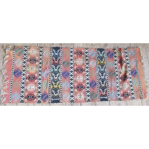 86 - A pink ground runner, 120ins x 32.5ins, together with a mat, 54ins x 21ins