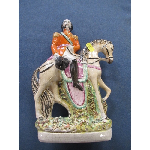 252 - Two Staffordshire models, of an Eastern soldier and a man in horseback, height 13ins and 10ins